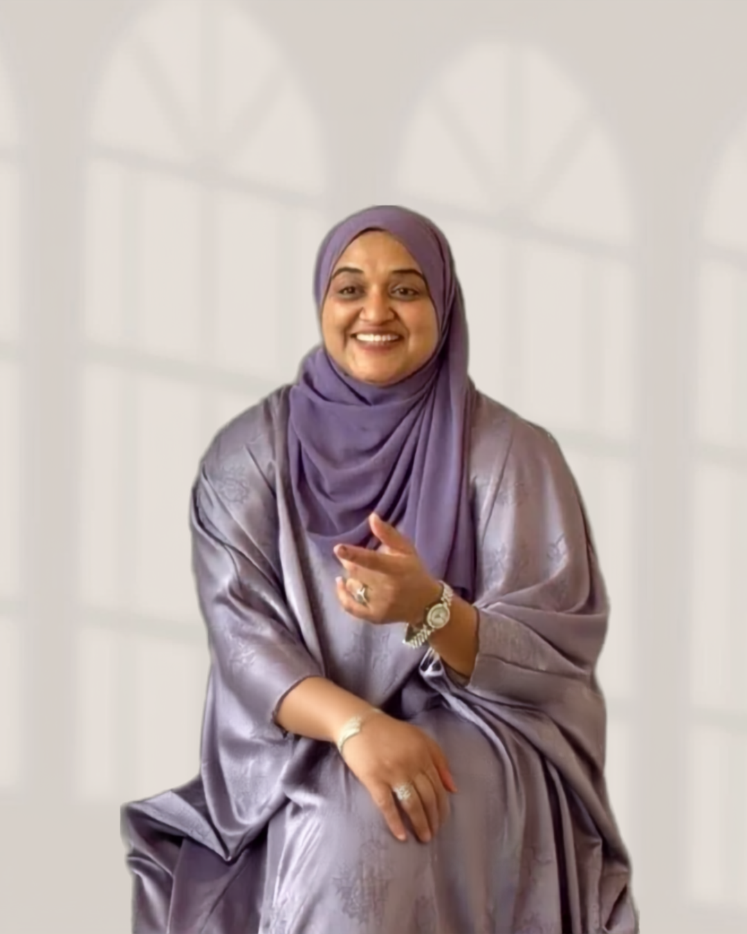 Mafaza Razeek seated, smiling warmly