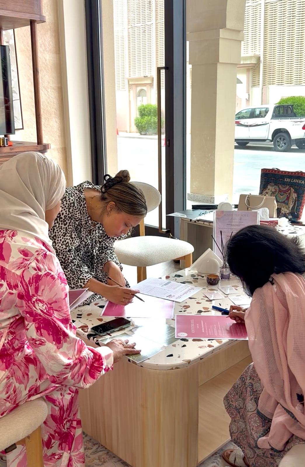 Women filling out registration materials at an Ignite The Soul event