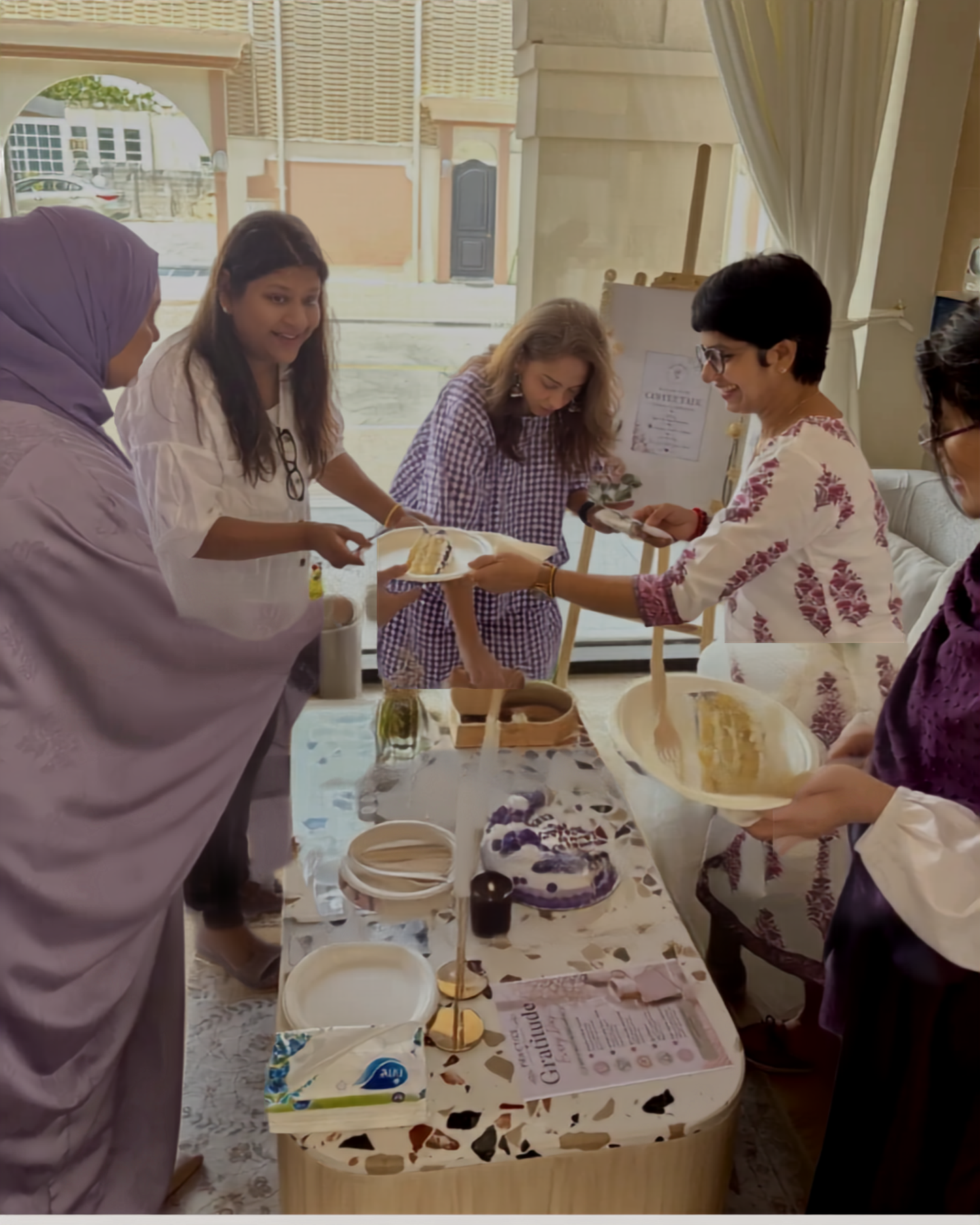 Women sharing a celebratory moment together at a Coffee Talk session