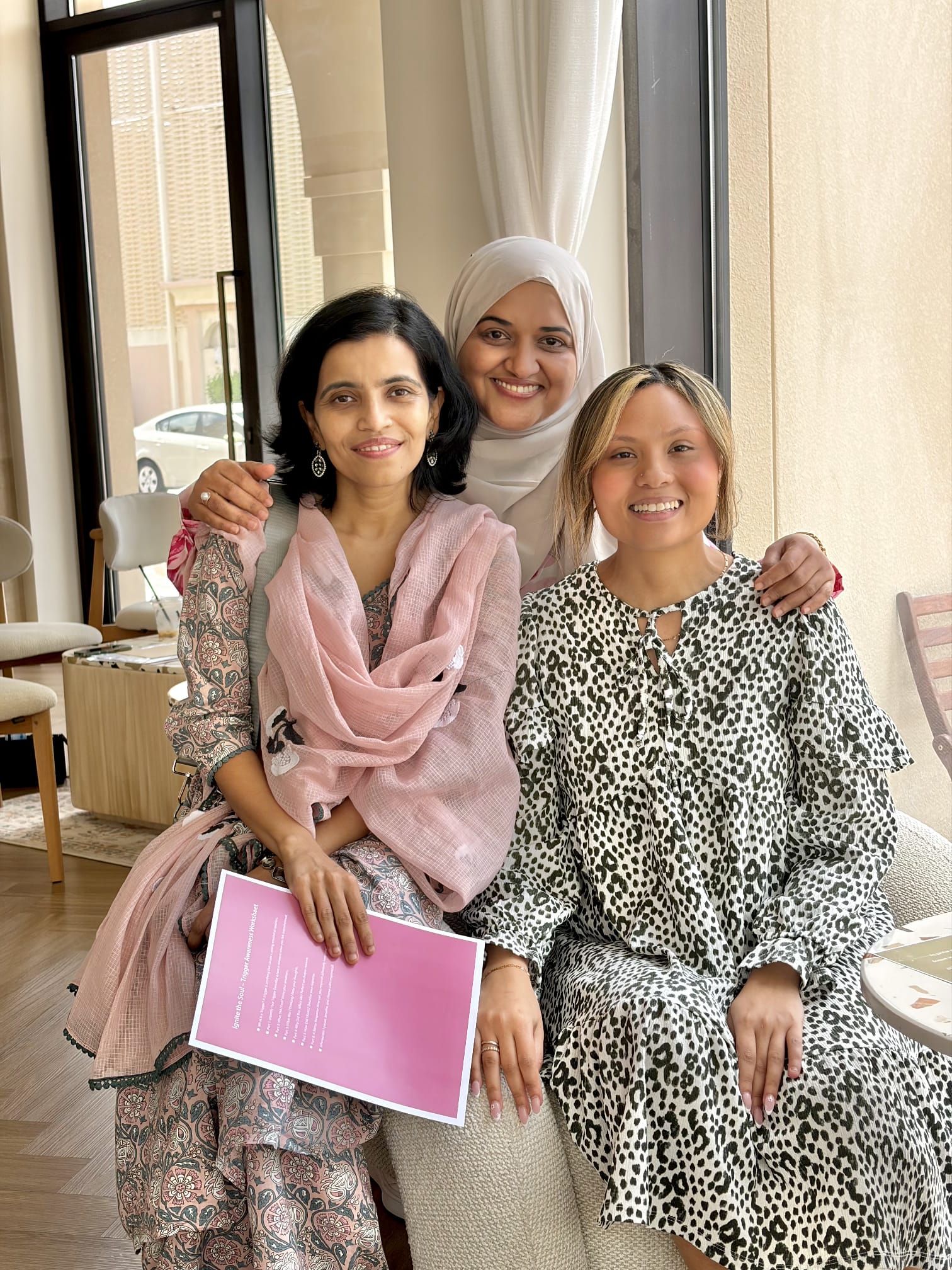 Three women smiling together at an Ignite The Soul session